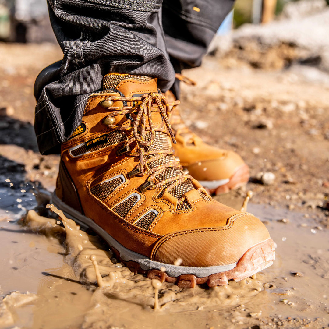 DEWALT Grader Men's Lightweight Work Boot Wheat, 3/4 Right View Model Stepping In Water