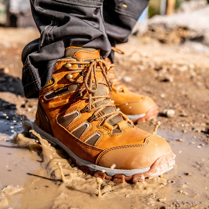 DEWALT Grader Men's Lightweight Work Boot Wheat, 3/4 Right View Model Stepping In Water